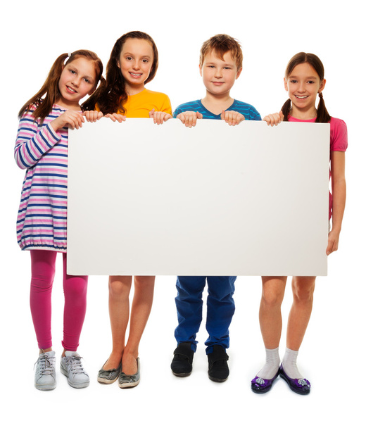 Four kids showing board with advertising - Foto, afbeelding