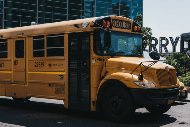 New York, USA - May 30, 2018: Yellow school bus on a road in New York. The City of New York provides student with free transportation to and from school. - Zdjęcie, obraz