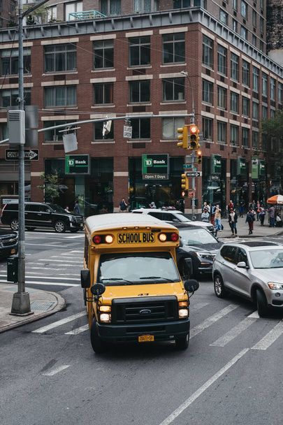 New York, USA - May 30, 2018: Yellow school bus parked on a road in New York. The City of New York provides student with free transportation to and from school. - Zdjęcie, obraz
