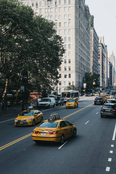 New York, USA - June 1, 2018: Numerous yellow taxis on the street in New York. Yellow taxis are recognised worldwide as the icons of the city. - Foto, Bild