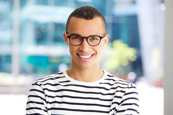 Close up horizontal portrait of handsome young man smiling with glasses - Photo, Image