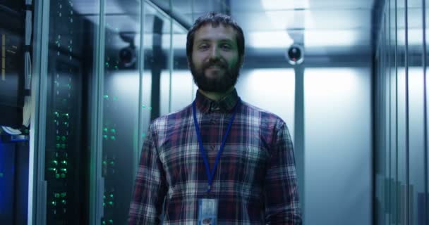 Adult bearded engineer in server room - Footage, Video