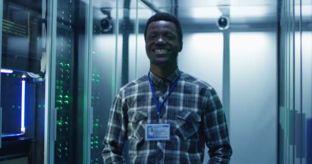 Smiling black man in server room - Footage, Video