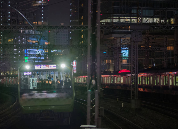 TOKYO, JAPAN - SEPTEMBER 15TH, 2018. East Japan Railway Yamanote  line passing thorugh Yurakucho Station tracks at night.. - Photo, Image