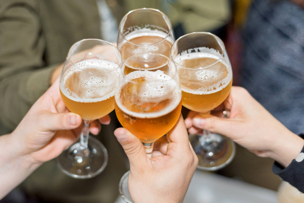 Grupa przyjaciół picia piwa, opiekanie, w pubie - Zdjęcie, obraz
