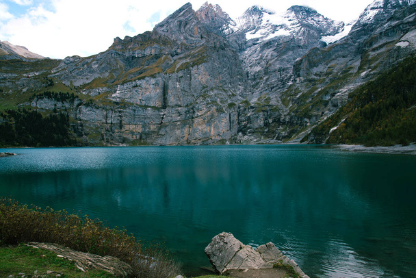 View of Oeschinen Lake in the Swiss alps with beautiful turquoise water. - Photo, Image