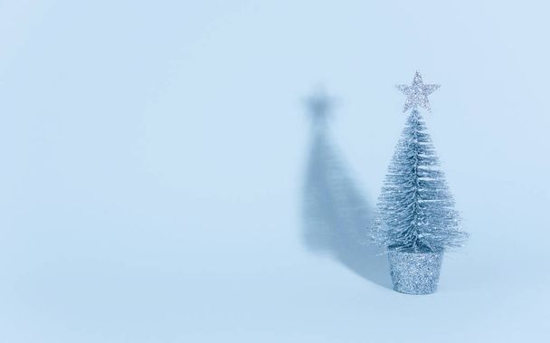 Christmas tree over light blue background. - Photo, Image