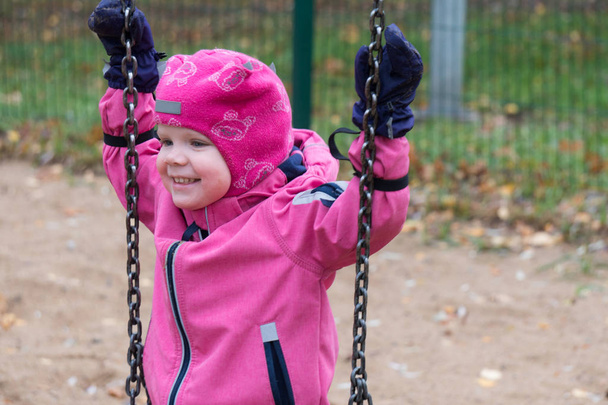 Child's emotion on the playground in cold autumn day - Foto, Imagem