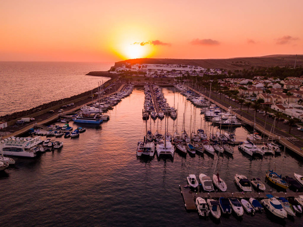 Beautiful aerial sunset view over the docks with many luxury yachts docked by the pier. - Photo, Image