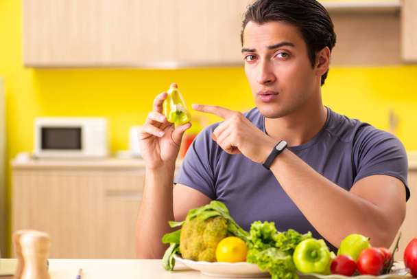 Young man in dieting and healthy eating concept - 写真・画像