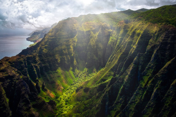 Landscape view of Na Pali coastline cliffs with sunlight glow, Kauai, Hawaii, USA - Photo, Image