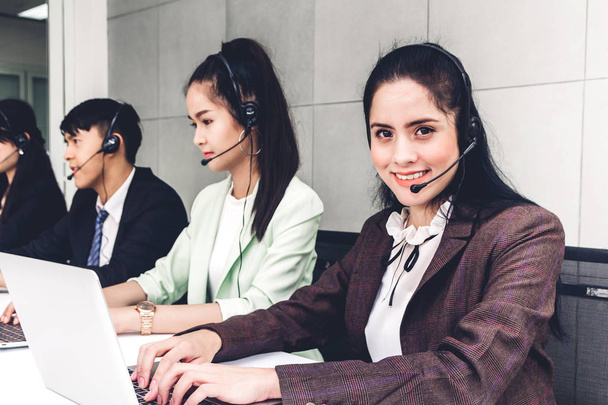 Beautiful businesswoman customer support services working with headset and computer at call center - 写真・画像
