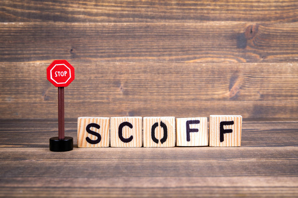 Ferma il concetto di Scoff. Lettere in legno con cartello stradale
 - Foto, immagini