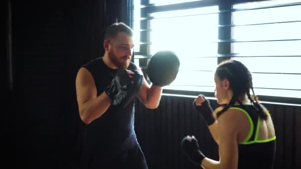 boxing coach training fit white female boxer at gym in slow motion. - Filmmaterial, Video
