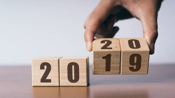 New year 2019 change to 2020 concept, hand change wooden cubes - Фото, зображення