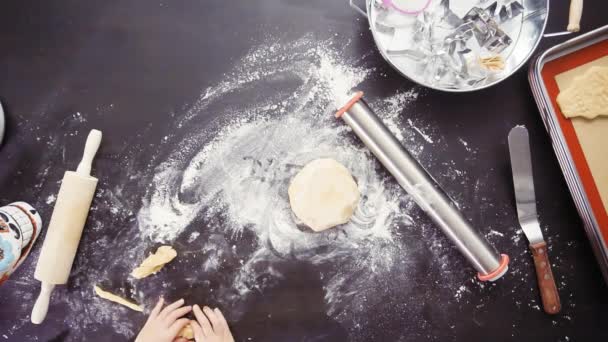 Overhead view of mother and daughter baking sugar skull cookies for Dia de los Muertos holiday. - Footage, Video