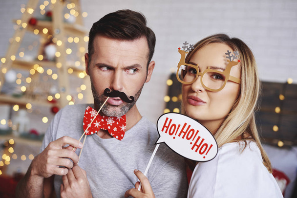 Portrait of young couple with christmas masks  - Photo, Image