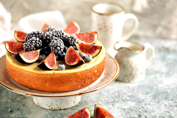 Homemade delicious cheesecake with fresh figs and frozen blueberries and blackberries. Healthy baking in multicooker - Photo, Image