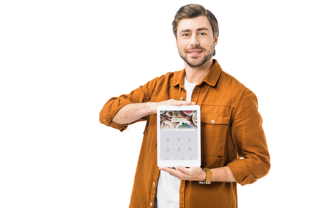 happy man showing digital tablet with foursquare on screen isolated on white - Photo, Image