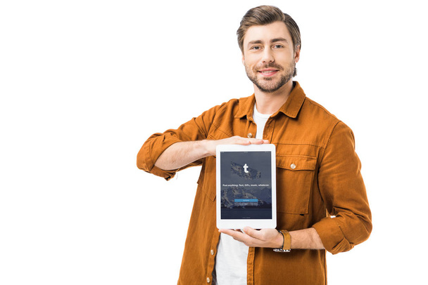 happy man showing digital tablet with tumblr on screen isolated on white - Фото, изображение