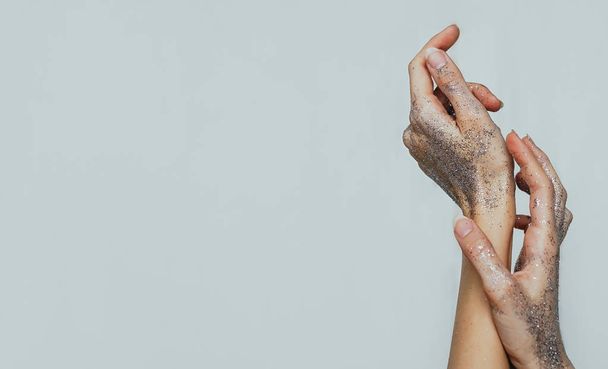 female hands covered in silver shiny glitter - Фото, зображення