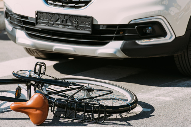 close up view of broken bicycle and car on road, car accident concept - Photo, Image