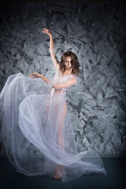 young elegant tender woman in lace lingerie posing on dark grey stone background - Fotografie, Obrázek