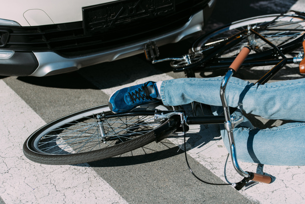 partial view of male bicycle rider hit by car on road, car accident concept - Foto, Imagem