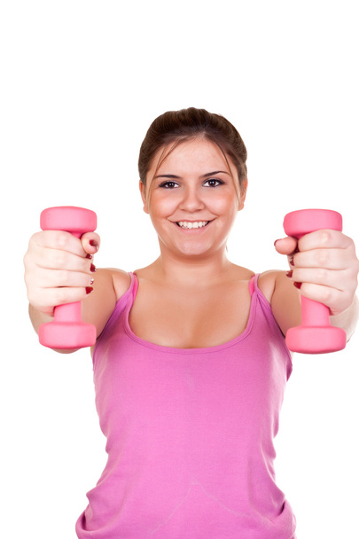 Smiling girl exercising with weights - Zdjęcie, obraz