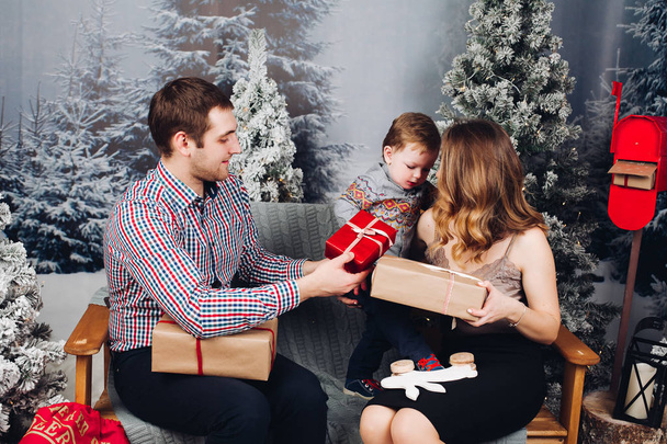 Lovely family enjoying christmas presents before holidays. - Foto, Imagen