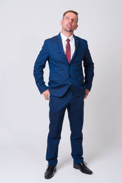Full body shot of blonde businessman wearing blue suit - Photo, Image