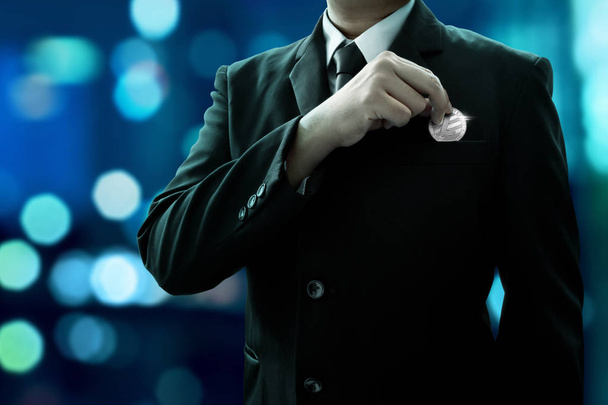 Businessman holding silver litecoin - Valokuva, kuva