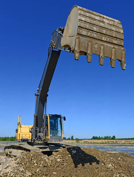 Extracting and loading gravel excavated in the mainstream of the river - Photo, Image