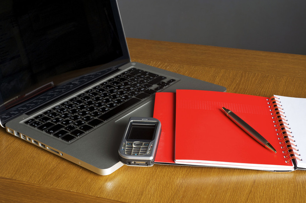 Phone, laptop and empty notebook on the desk - Fotoğraf, Görsel