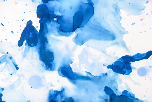 blue splashes of alcohol ink on white as abstract backdrop  - Photo, Image