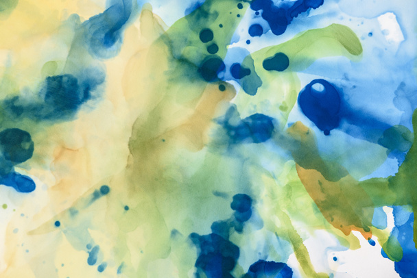 yellow, green and blue splashes of alcohol inks as abstract background - Fotoğraf, Görsel