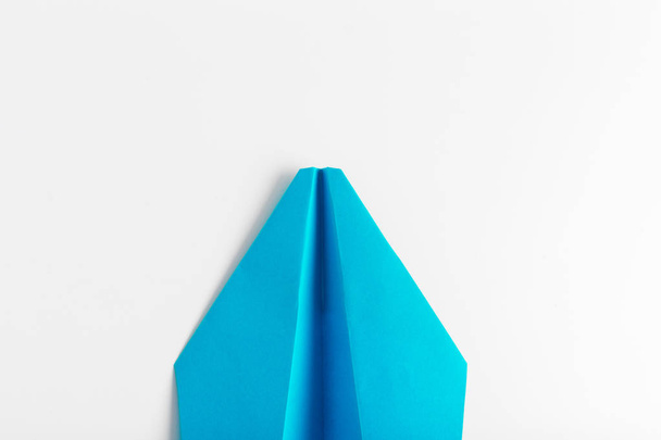 Flat lay of white paper plane on white color background - 写真・画像