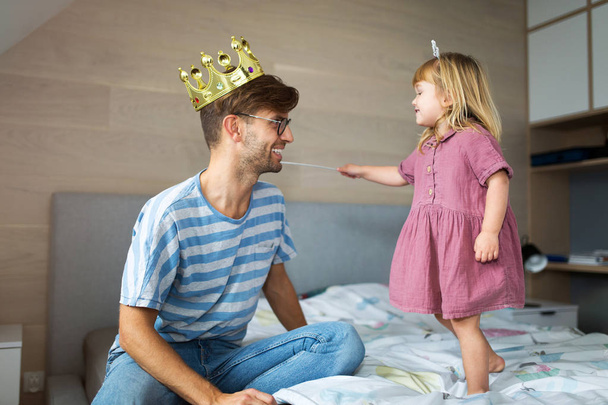 Daughter casting spell on father with magic wand - Foto, Imagem