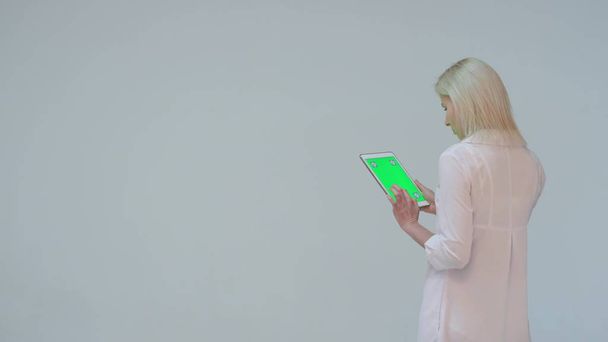 Doctor pressing the green screen of a tablet computer against white background - Foto, Imagem