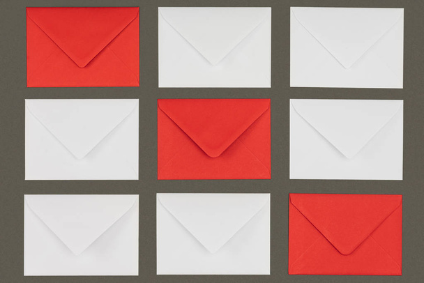 close-up view of closed red and white envelopes isolated on grey background - Zdjęcie, obraz