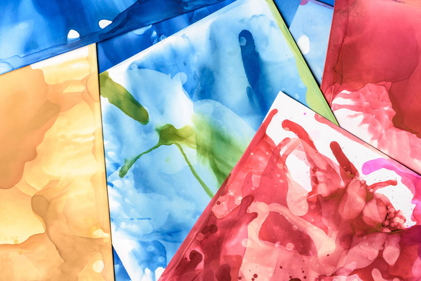 blue, red and green splashes of alcohol inks as abstract background - Photo, Image
