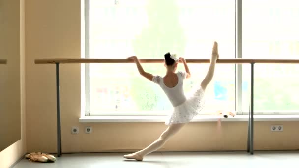 Ballerina is practicing in studio, back view. - Footage, Video