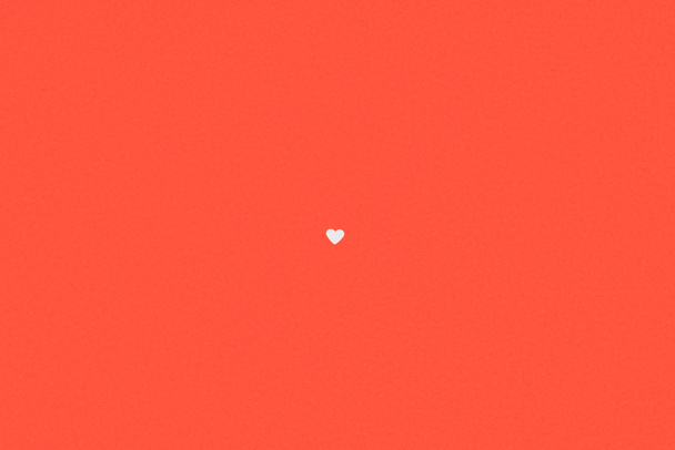 small single white heart symbol isolated on red background - Φωτογραφία, εικόνα