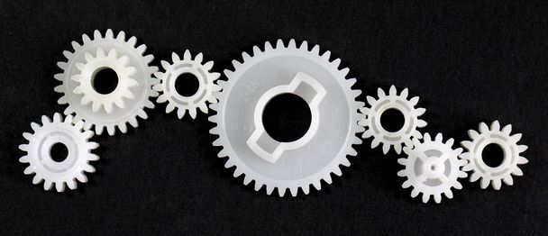 Several gears that are in connection with each other on black background - Photo, Image