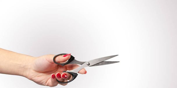 Woman hand with  scissors isolated on color background - Valokuva, kuva