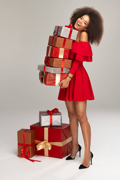 Female model wear red dress keeps gifts - Valokuva, kuva