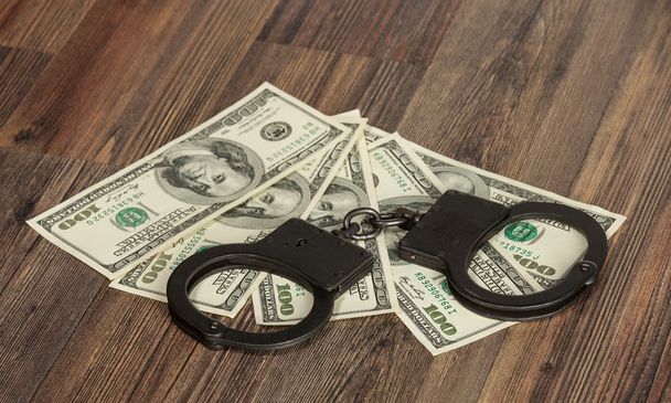 Handcuffs and money - Фото, изображение