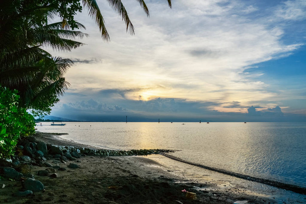 Beautiful tropical seascape with palm trees at sunrise on Bali - Zdjęcie, obraz