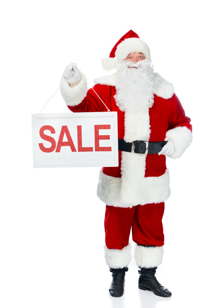 happy santa claus holding sale board isolated on white - Fotó, kép