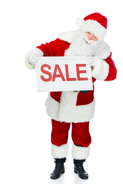 santa claus in red costume holding sale board isolated on white - Фото, зображення